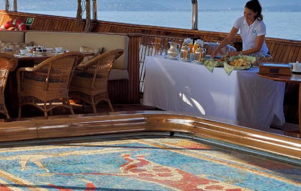 luxury yachts - woman preparing food at buffet on a yacht
