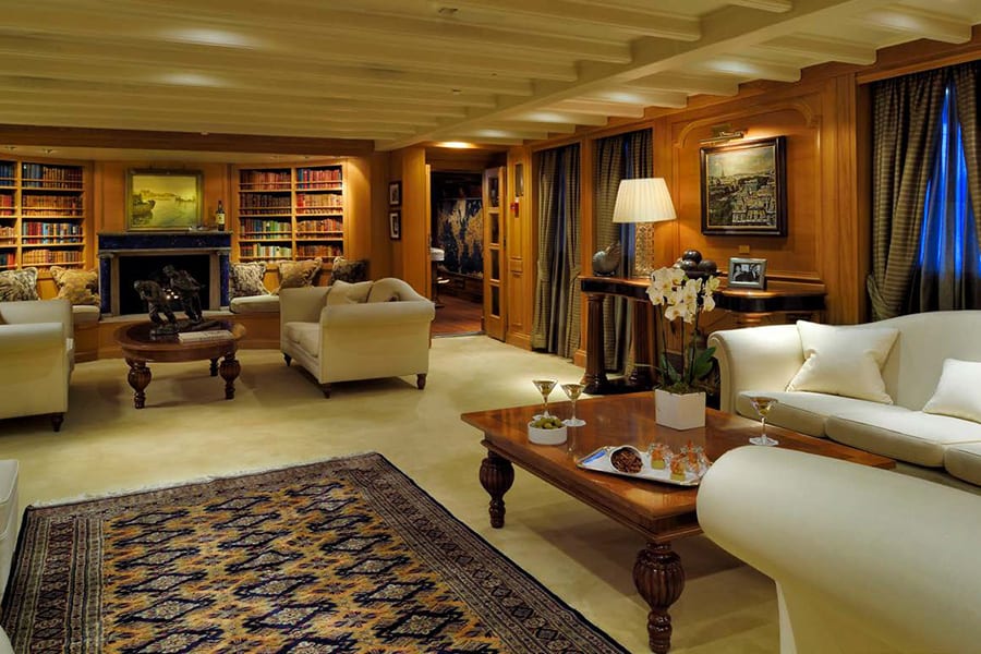 luxury yachts - living room of yacht with library ad sofas