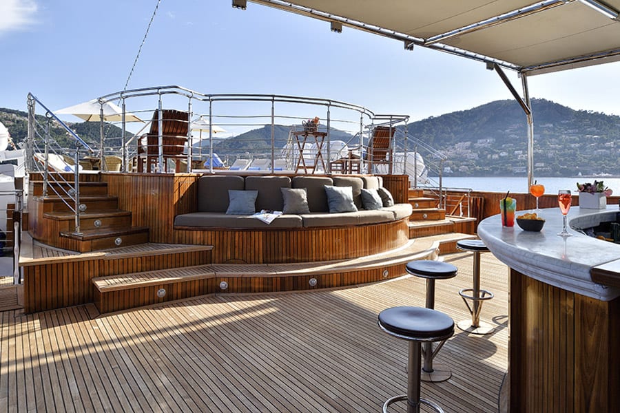 luxury yachts - outside view of yacht deck with bar and drinks with whirlpool