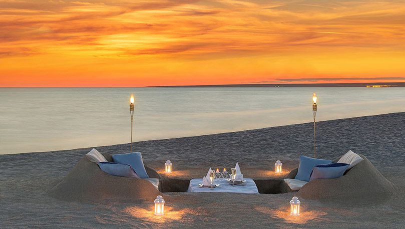 luxury experiences - beautiful dinner at the beach at sunset