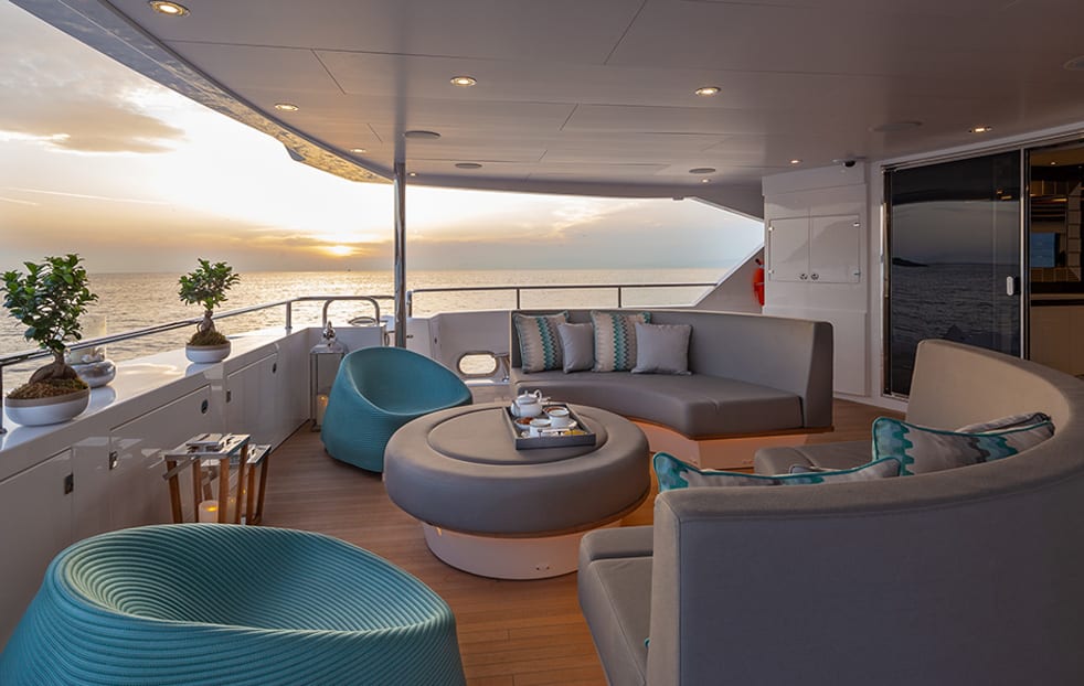 luxury yachts - covered terrace of yacht with seating area