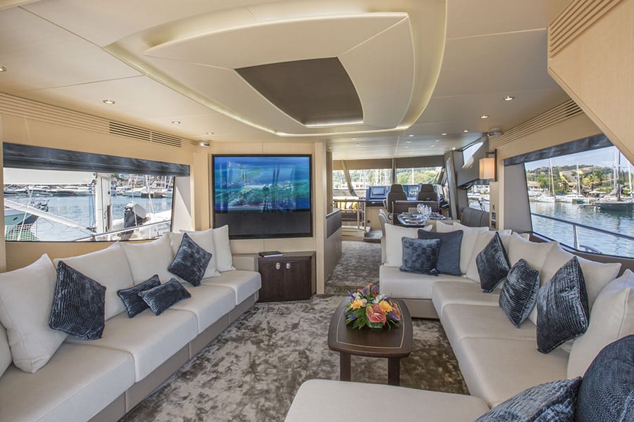 luxury yachts - living room of yacht with large sofa and tv
