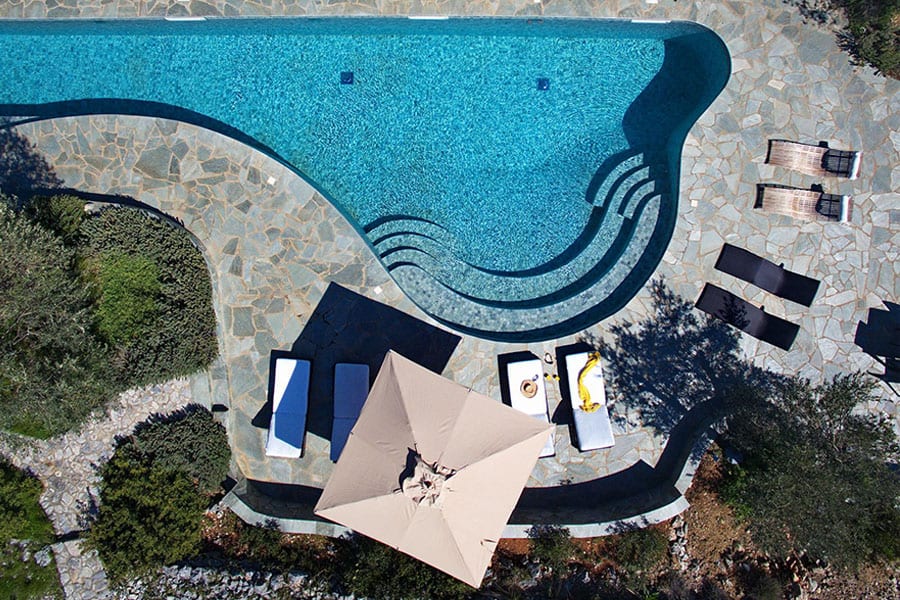 luxury villas - drone shot of pool with sun beds