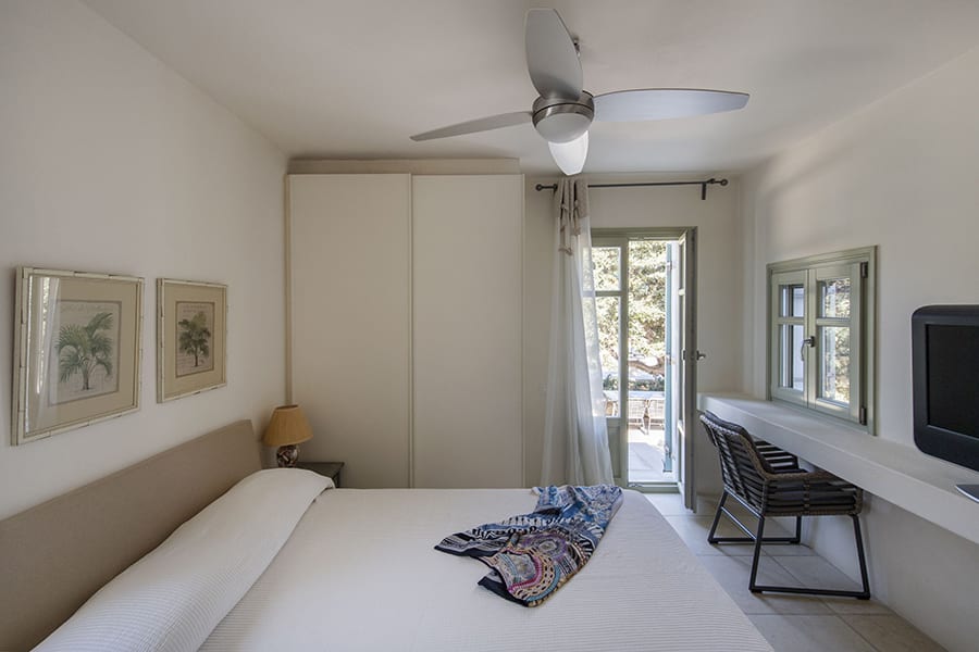 luxury villas - bedroom with double bed and tv and open door to terrace