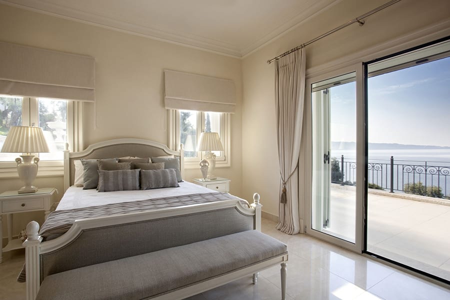luxury villas - luxurious bedroom with double bed and view to terrace and sea view