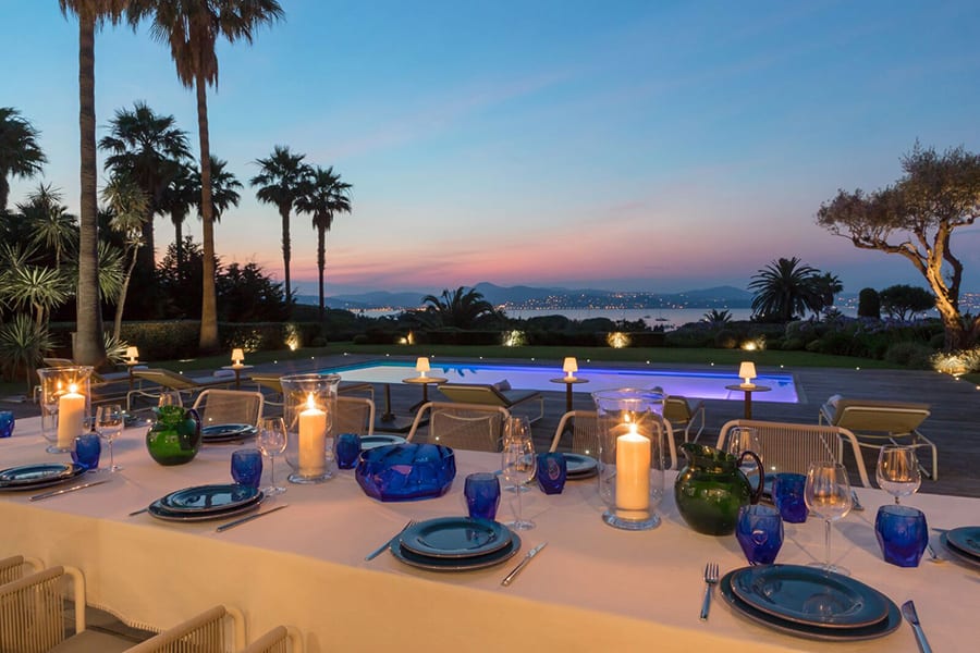 luxury villas - outside dining table beautiful set up and pool with sea view at sunset