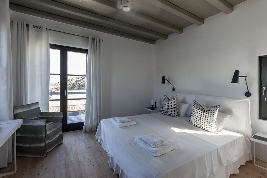 luxury villas - 2 bed bedroom with chair wood floor and patio door