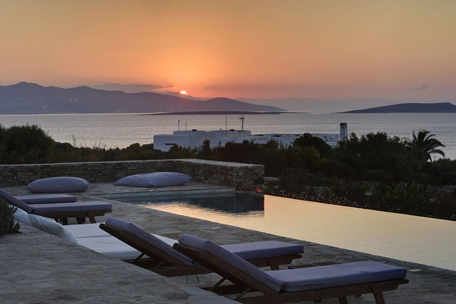 luxury villas - pool with sun beds at sunset