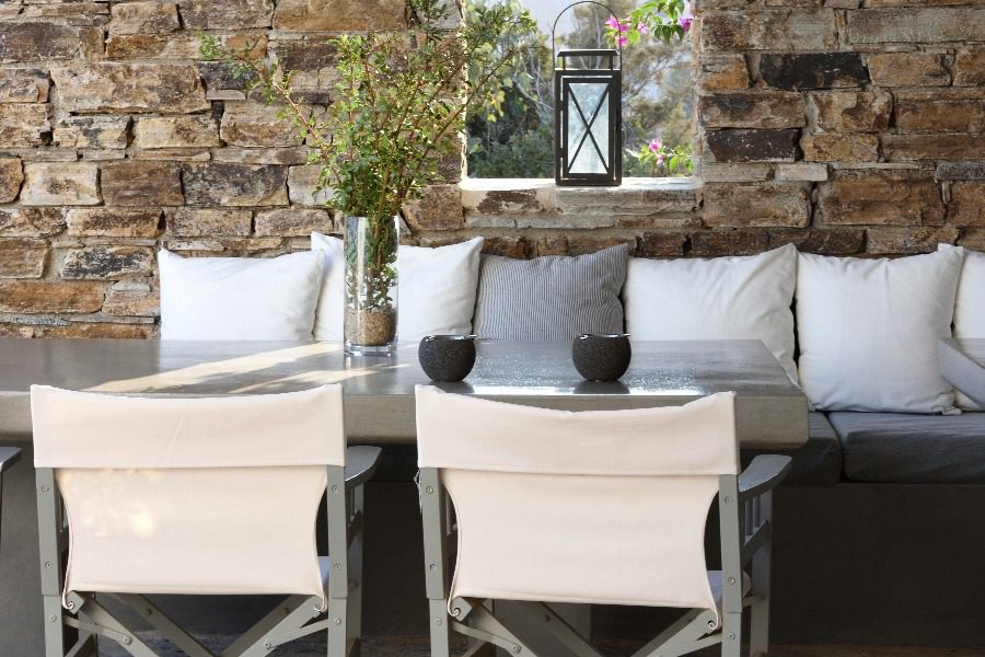 luxury villas - outside dining table with chairs and pillows
