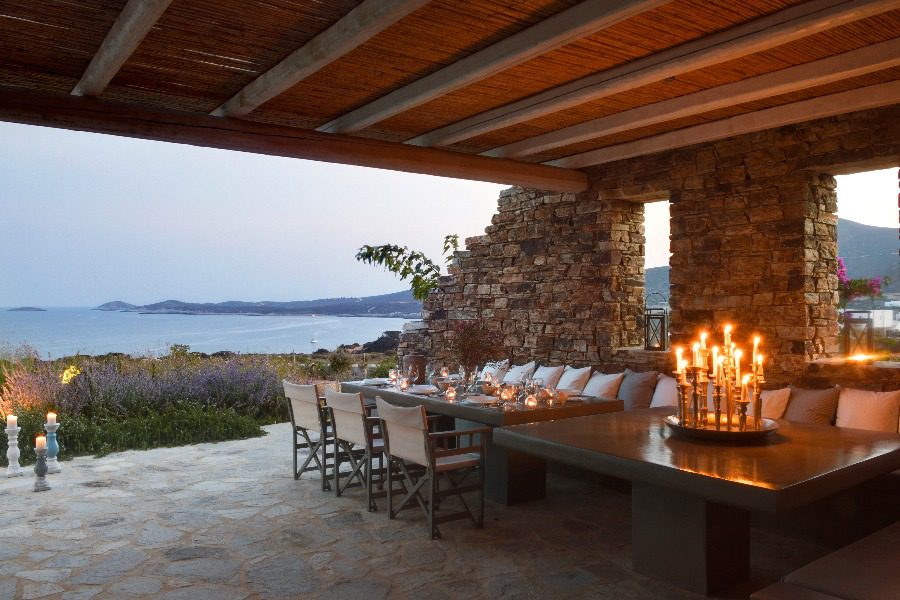 luxury villas - outside dining area with beautiful set up table and candles at sunset with stunning sea view