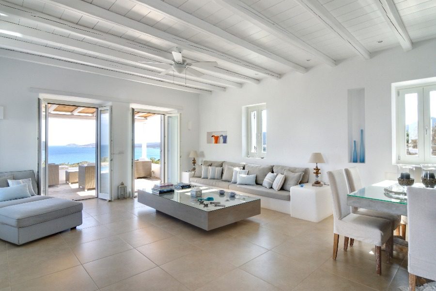 luxury villas - living room with armchair and view to beautiful terrace and sea view