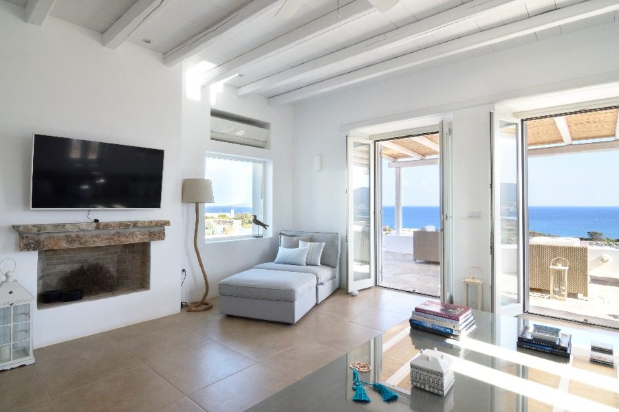 luxury villas - living room with armchair and view to beautiful terrace and sea view