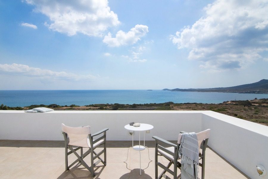 luxury villas - rooftop patio with chairs and table and beautiful sea view