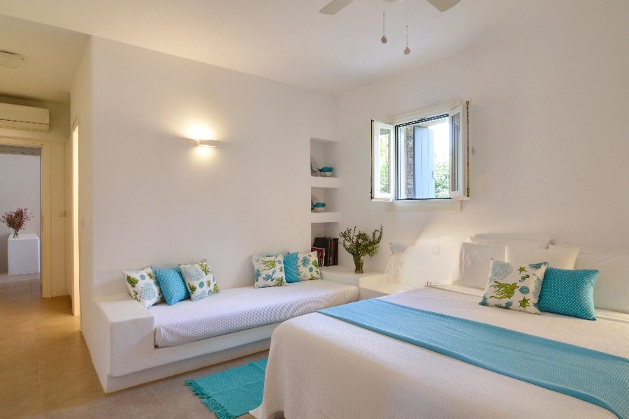 luxury villas - bedroom with double bed and sofa