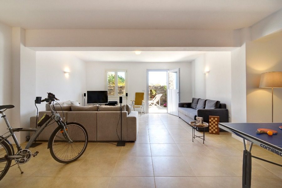 luxury villas - living room with sofas and ebike