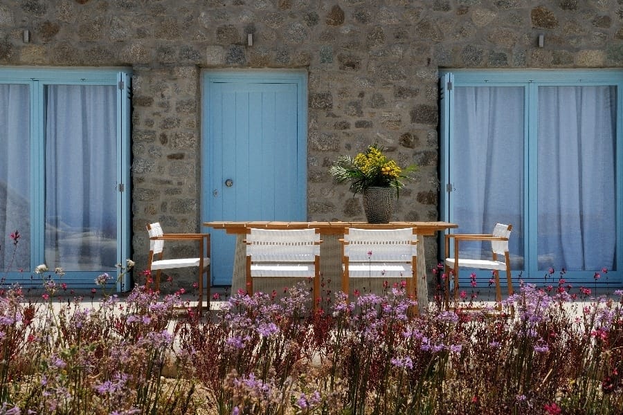 luxury villas - outside dining area with wild flowers with chairs and table