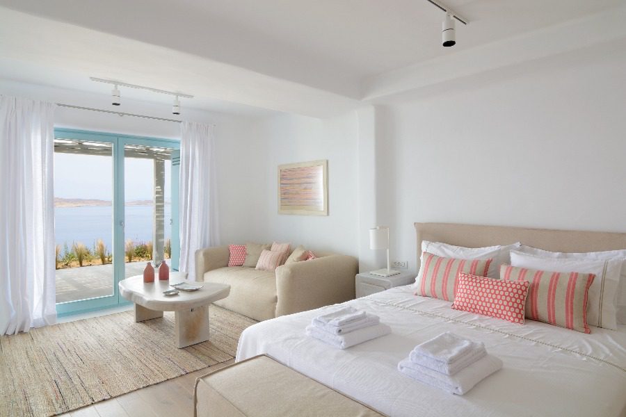 luxury villas - bedroom with double bed in bright colors with terrace