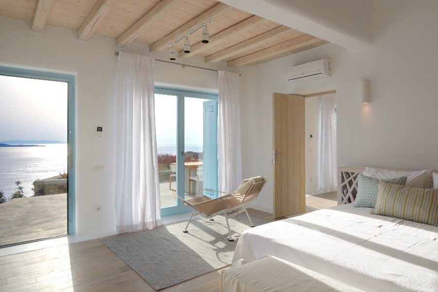 luxury villas - bedroom with double bed and terrace with sea view