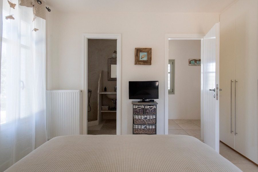luxury villas - bedroom with double bed and tv