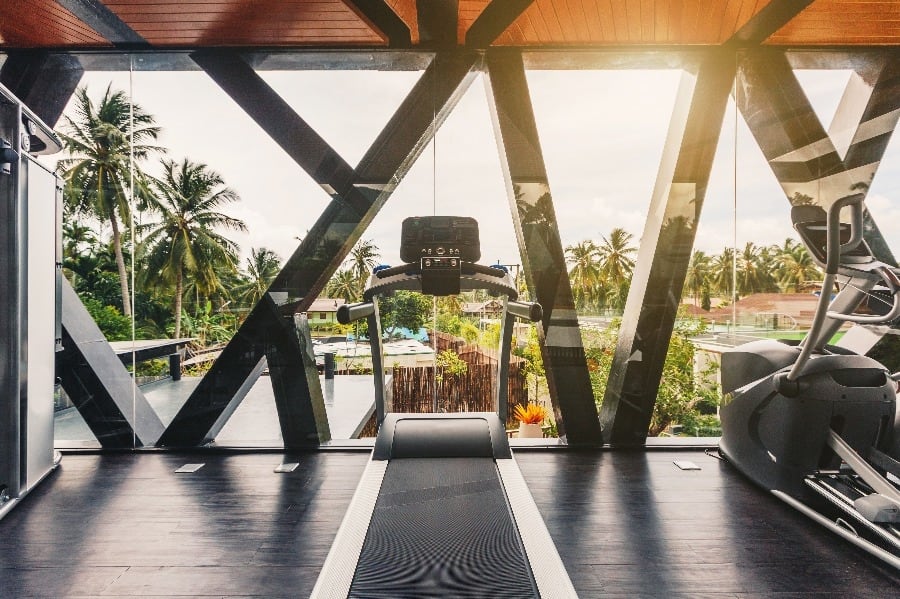 luxury villas - fitness room with view to palm trees