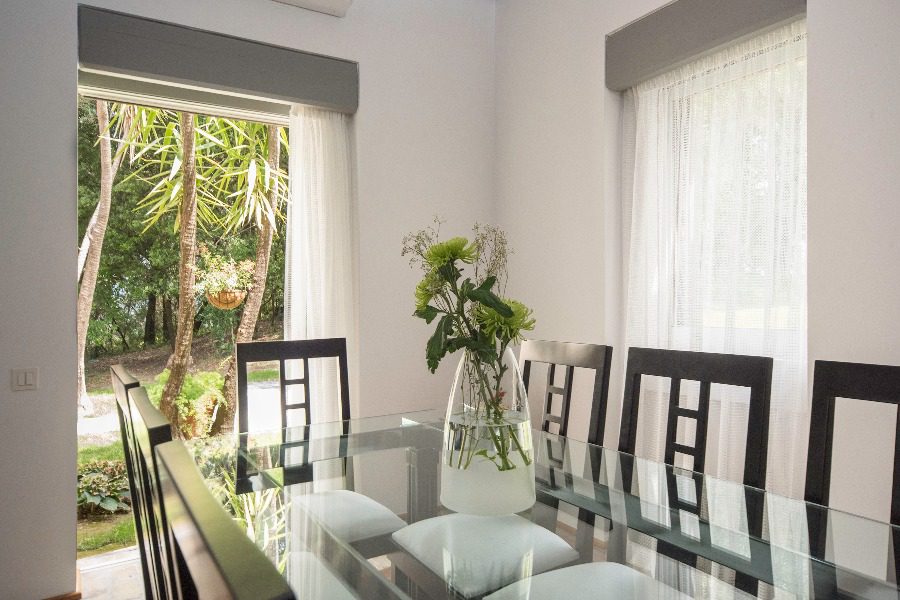 luxury villas - dining table with chairs and view to garden