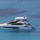 luxury yachts - side view of yacht with people sunbathing