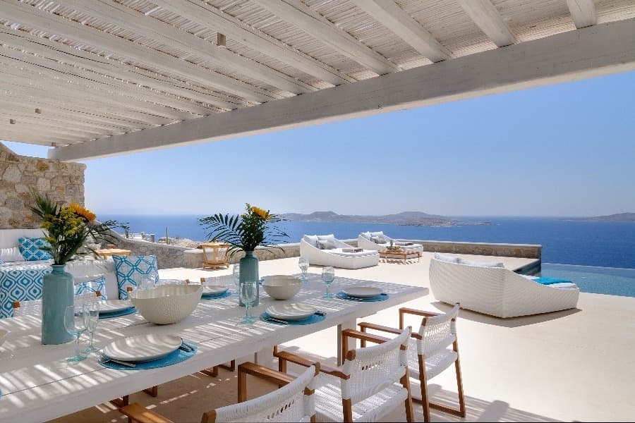 luxury villas - outside dining table with pool and sea view