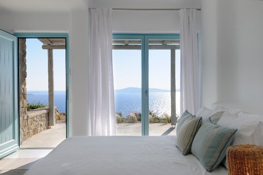 luxury villas - bedroom with double bed and terrace with sea view