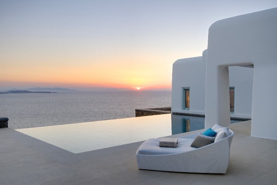 luxury villas - outside relaxing lounge with pool and sunset view