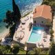 luxury villas - drone shot of villa at the sea with pool and car