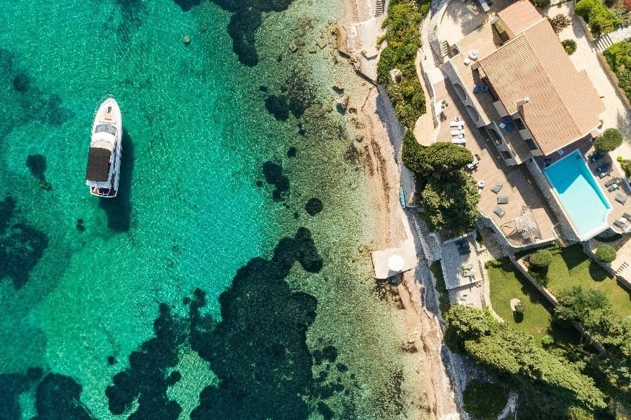 luxury yachts - drone shot of the sea and villa