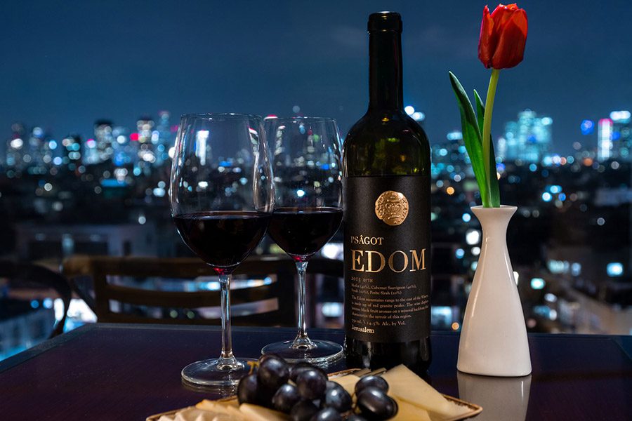 luxury experiences - red wine with two glasses and flower