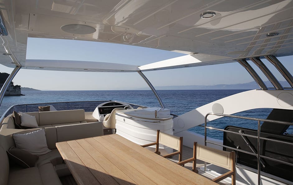 luxury yachts - covered deck with table and lounge