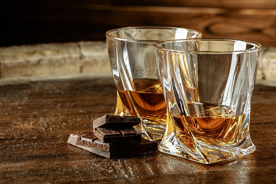 luxury services - two glasses of whiskey with chocolate