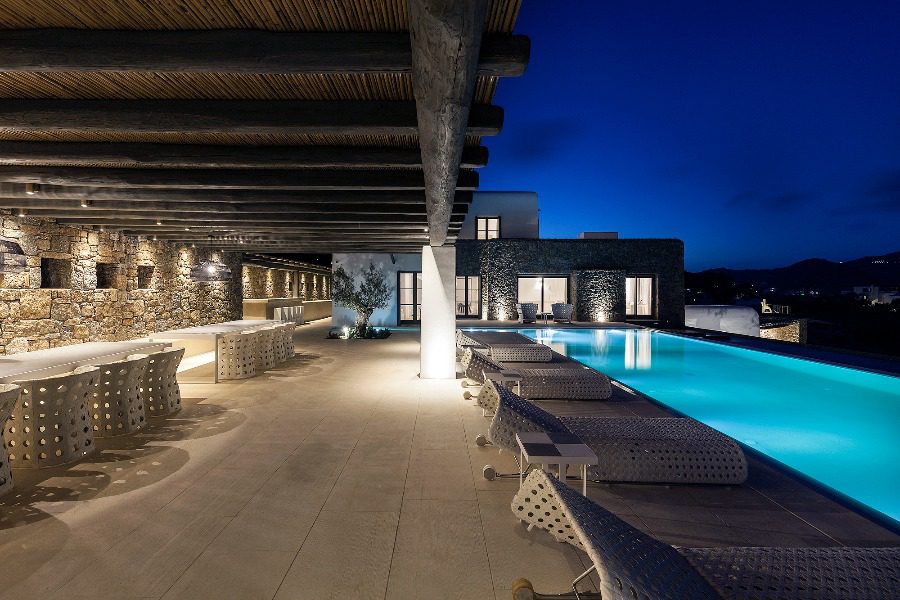 luxury villas - outside relaxing area with pool by night
