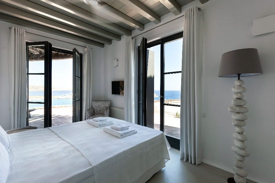 luxury villas - bedroom with double bed and view to terrace and the sea