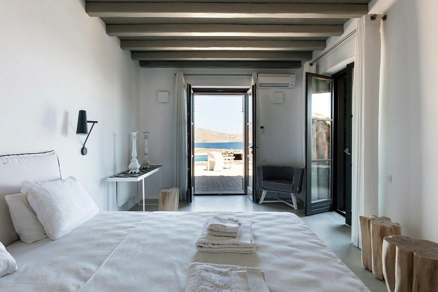luxury villas - bedroom with double bed and stunning view to terrace and the sea