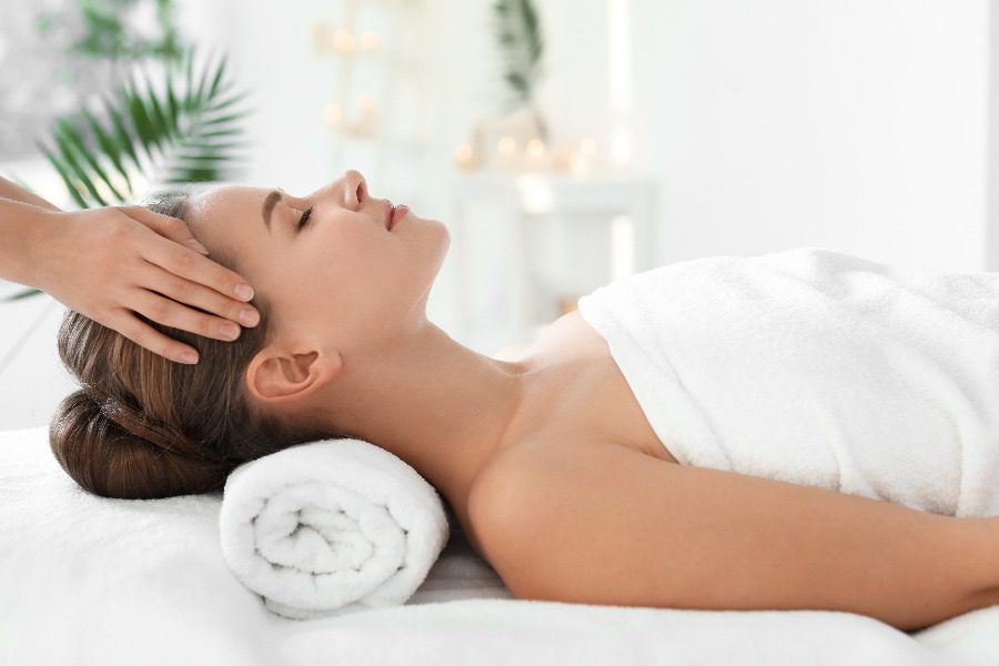 luxury experiences - women having a head massage
