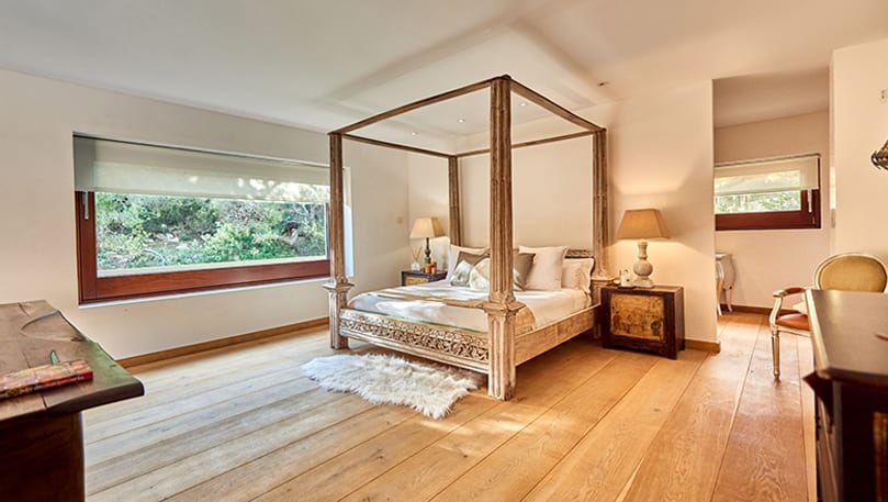 luxury villas - bedroom with double bed and wooden floor