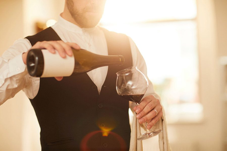luxury experiences - man pouring wine