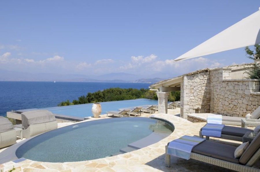 luxury villas - pool with sun beds and sea view
