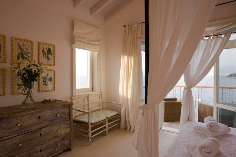 luxury villa - bedroom with canopy bed and terrace with sea view