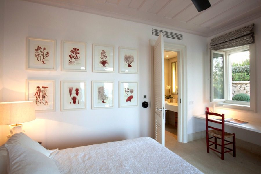 luxury villas - bedroom with double bed and paintings on the wall