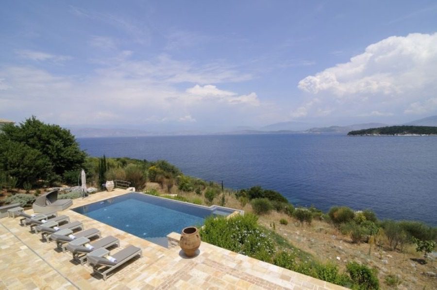 luxury villas - sun beds at the pool with sea view