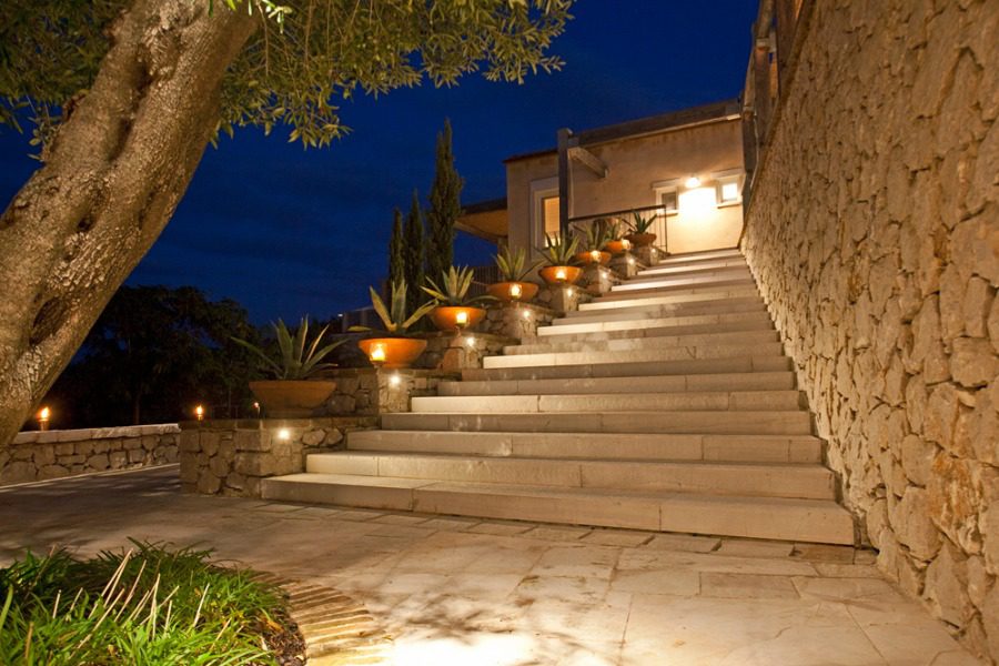 luxury villas - entrance with stairs and lights to the villa by night