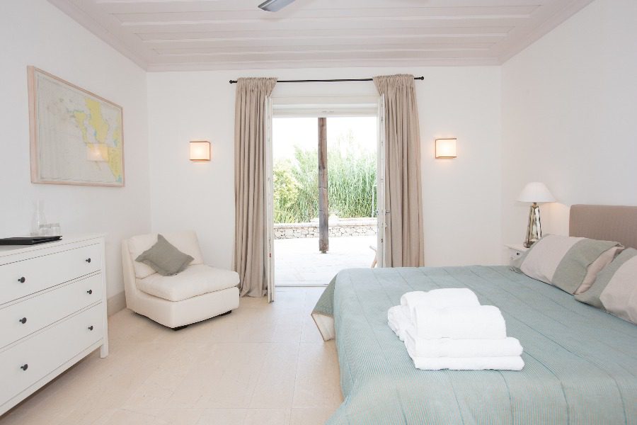 luxury villas - bedroom with double bed and towels with terrace