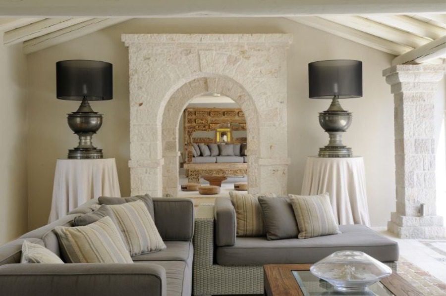 living room with stone archway and sofas