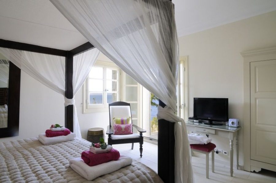 luxury villas - bedroom with canopy bed and tv