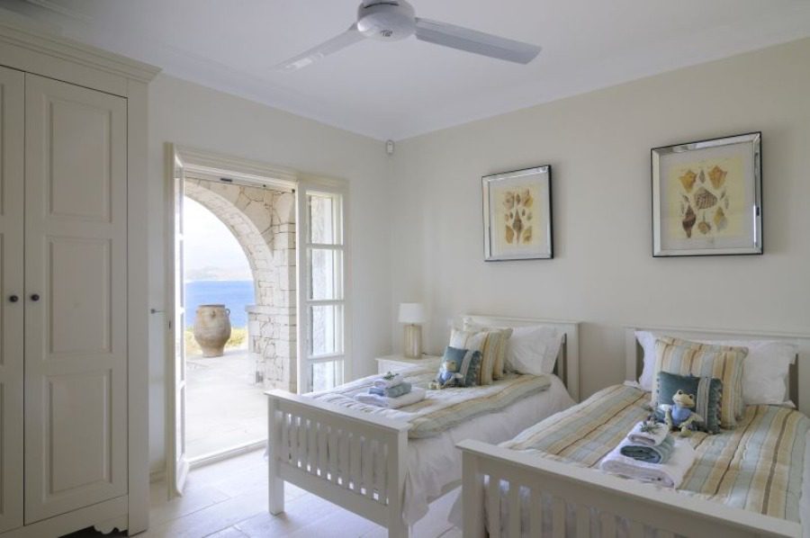 luxury villas - bedroom with two single beds and open door to terrace