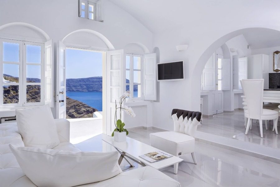 luxury villas - white living room with open door to balcony with sea view